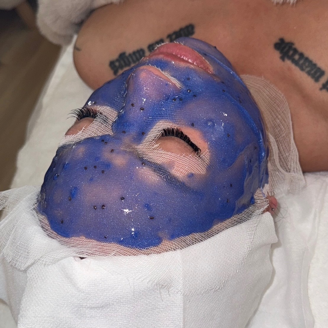 Client wearing a purple Hydrojelly mask during a facial