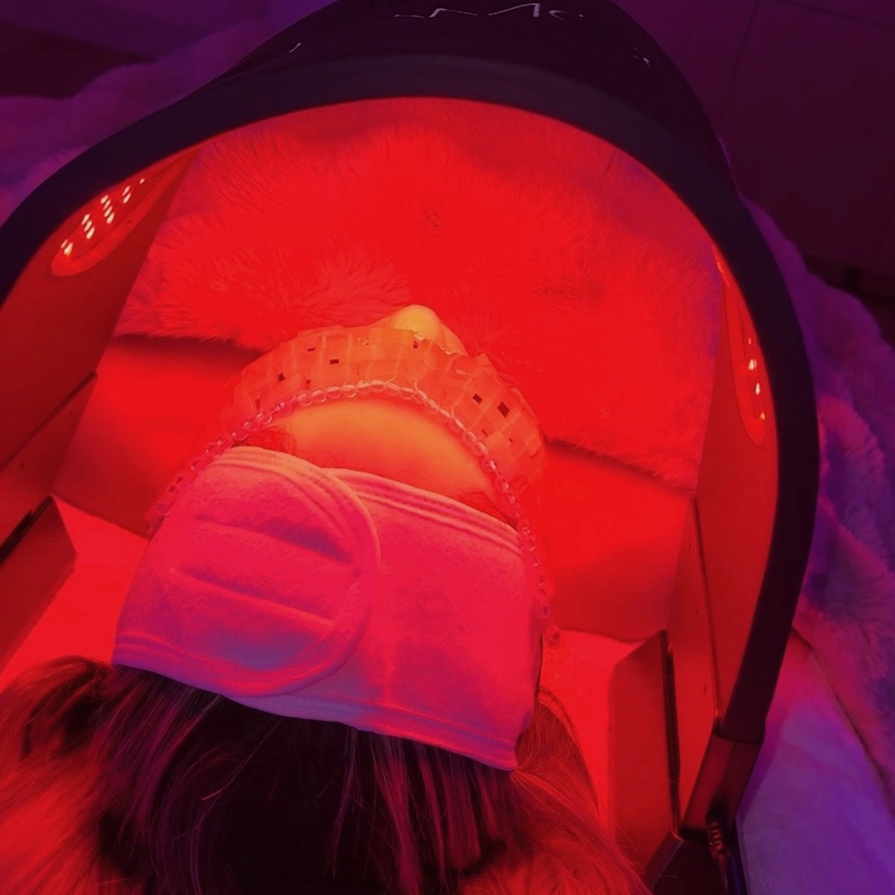 Client receiving red LED light therapy during a facial