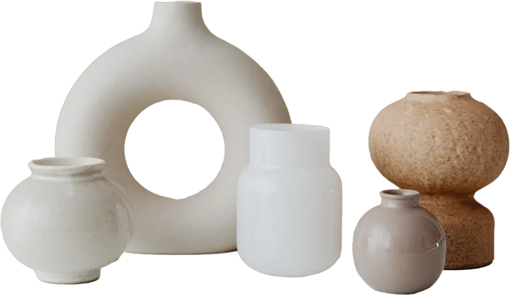 Assortment of five minimalist vases in neutral colors, with various shapes and textures.
