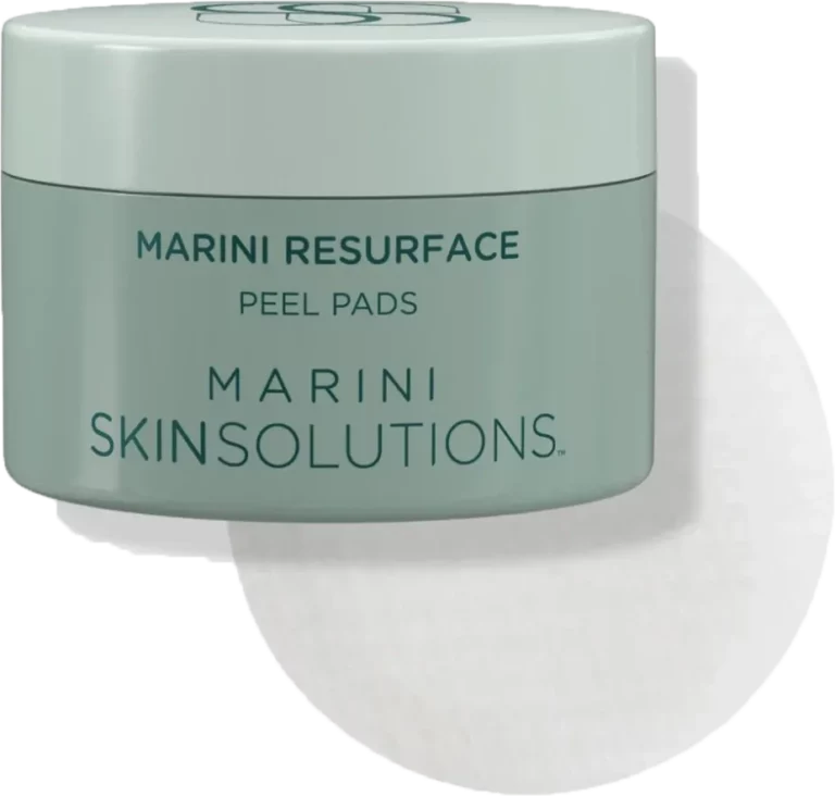 Green jar labeled Marini Resurface Peel Pads with a round white pad behind it